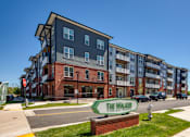 Thumbnail 24 of 40 - The Walker apartments are located in a sunny, urban area.