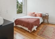 Thumbnail 16 of 46 - a bedroom with a bed and a ceiling fan