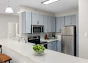 Thumbnail 7 of 45 - A kitchen with a bowl of green apples on the counter.