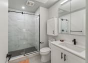 Thumbnail 17 of 46 - a white bathroom with a shower toilet and sink