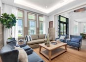 Thumbnail 31 of 35 - a living room with couches and chairs and a coffee table at The Enclave at Deer Moss Creek, Niceville