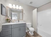 Thumbnail 14 of 45 - A bathroom with a white toilet and sink.