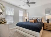 Thumbnail 11 of 29 - a bedroom with a bed and a ceiling fan