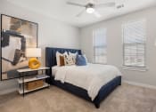 Thumbnail 14 of 29 - a bedroom with a bed and a ceiling fan