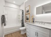 Thumbnail 15 of 29 - a bathroom with a shower and a sink and a toilet