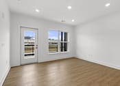 Thumbnail 3 of 44 - A room with a white wall and a wooden floor.