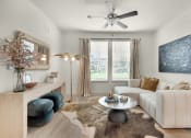 Thumbnail 3 of 35 - a living room with a white couch and a ceiling fan at The Enclave at Deer Moss Creek, Niceville, 32578
