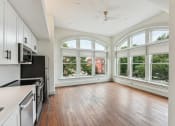 Thumbnail 1 of 46 - an empty kitchen with large windows and wood floors