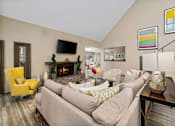 Thumbnail 47 of 67 - A living room with a grey couch and a yellow chair.