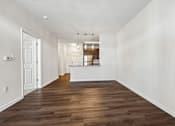 Thumbnail 35 of 51 - A long, empty hallway with wooden floors and white walls.