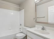 Thumbnail 40 of 54 - A white bathroom with a toilet, sink, and bathtub.