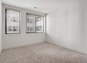 Thumbnail 35 of 52 - A room with two windows and carpeted floor.