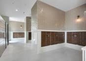 Thumbnail 32 of 35 - a large locker room with wooden lockers and a brick wall at The Enclave at Deer Moss Creek, Niceville