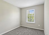 Thumbnail 39 of 54 - A room with a window and carpeted floor.