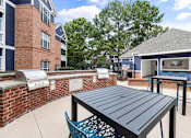 Thumbnail 35 of 45 - A black table is in the middle of a patio.