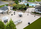 Thumbnail 24 of 50 - A gazebo is surrounded by tables and chairs in a courtyard.