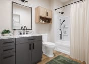 Thumbnail 20 of 44 - a bathroom with a shower and a sink and a toilet at Boardwalk at Research Park in Huntsville, Alabama 35811