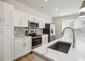 Thumbnail 1 of 31 - a large kitchen with white cabinets and a sink at The Falstaff, North Carolina, 27610