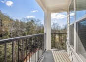 Thumbnail 7 of 31 - a balcony with a view of trees and a blue sky at The Falstaff, Raleigh