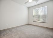 Thumbnail 3 of 31 - an empty room with a window and a ceiling fan at The Falstaff, North Carolina, 27610