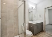 Thumbnail 5 of 31 - a bathroom with a shower and a sink and a toilet at The Falstaff, Raleigh, 27610