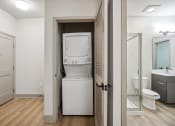 Thumbnail 6 of 31 - a small bathroom with a washer and dryer in a closet at The Falstaff, Raleigh, NC