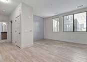 Thumbnail 44 of 52 - A spacious room with light wood flooring and white walls.