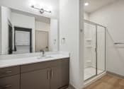 Thumbnail 13 of 31 - a bathroom with a sink and a shower and a mirror at The Falstaff, Raleigh