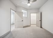 Thumbnail 12 of 31 - an empty room with a ceiling fan and doors at The Falstaff, Raleigh