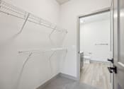 Thumbnail 20 of 31 - a walk in closet in a white room with a mirrored door and a white toilet at The Falstaff, Raleigh, NC