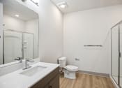 Thumbnail 21 of 31 - a bathroom with a toilet sink and shower and a mirror at The Falstaff, North Carolina