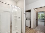 Thumbnail 22 of 31 - a bathroom with a shower and a washer and dryer in it at The Falstaff, Raleigh