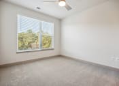 Thumbnail 19 of 31 - an empty bedroom with a large window and carpeting at The Falstaff, North Carolina, 27610