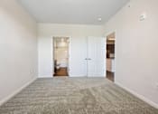 Thumbnail 38 of 51 - A large, empty room with a carpeted floor and white walls.