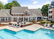 Thumbnail 27 of 45 - A large house with a pool in front.