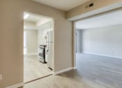 Thumbnail 44 of 52 - an empty living room and kitchen with a door open to the dining room at Bayville Apartments, Virginia Beach, 23455