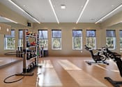 Thumbnail 5 of 51 - A gym with exercise equipment and windows.