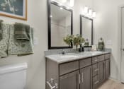 Thumbnail 5 of 35 - a bathroom with a sink and a mirror at The Enclave at Deer Moss Creek, Niceville, FL, 32578