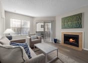 Thumbnail 15 of 67 - A living room with a fireplace and a painting on the wall.