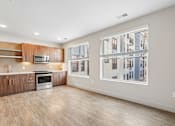 Thumbnail 50 of 64 - A kitchen with wooden cabinets and a microwave is visible.