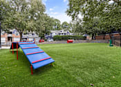 Thumbnail 37 of 45 - A blue and red slide in a grassy park.