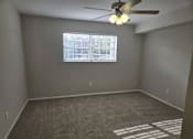 Thumbnail 37 of 45 - A room with a ceiling fan and a window with blinds.