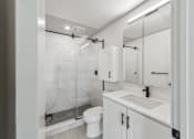 Thumbnail 11 of 46 - a white bathroom with a shower toilet and sink