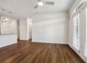 Thumbnail 26 of 51 - A room with wooden floors and a ceiling fan.