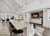 Thumbnail 7 of 50 - A modern living room with a long wooden table and black chairs.