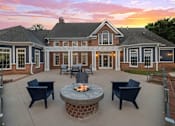 Thumbnail 33 of 45 - A house with a patio and a fire pit.