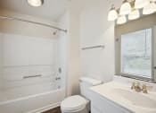 Thumbnail 6 of 46 - a bathroom with a sink toilet and a bath tub