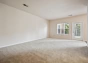 Thumbnail 14 of 46 - an empty living room with white walls and a window