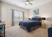 Thumbnail 4 of 46 - a bedroom with a bed and a ceiling fan