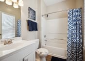 Thumbnail 3 of 46 - a bathroom with a sink and a toilet and a shower